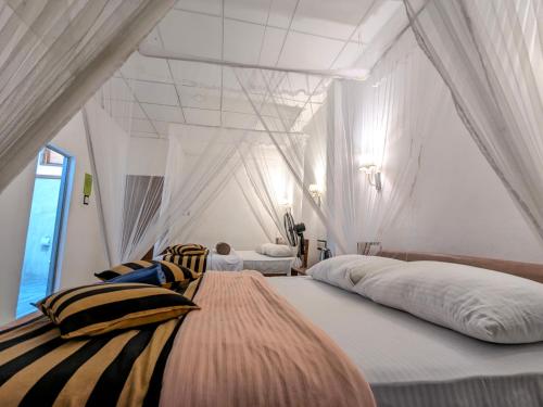 a bedroom with two beds in a room at New Green View Guest House Kithal Ella in Badulla