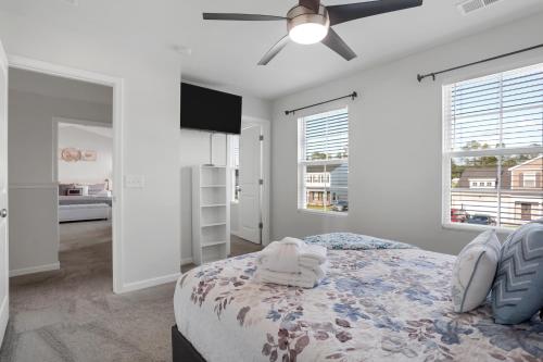 a bedroom with a bed with a ceiling fan at The Beautiful 31 in Port Wentworth