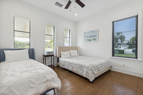 a white room with two beds and a window at 140 Ocean Estates Dr in Lakewood Park