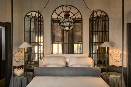 a bedroom with a bed with four windows at The Franklin London - Starhotels Collezione in London