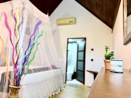 a room with a bed with a curtain and a table at Maika safari lodge in Udawalawe