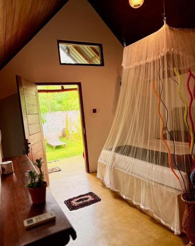 a bedroom with a bed with a mosquito net at Maika Safari Lodge in Udawalawe