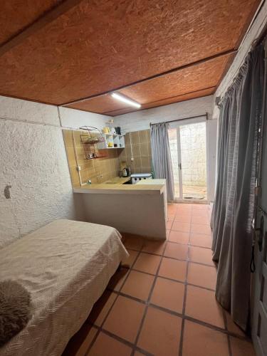 a room with a bed and a bathroom with a sink at Monoambiente Caracol chico in Aguas Dulces