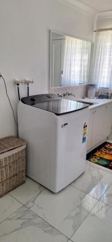 a kitchen with a large white island in a room at Aeris Holiday Home Flinders NSW Pet Friendly in Croom