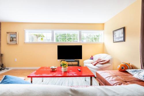 a living room with two couches and a flat screen tv at Fresh Space Quiet Air Studio in Mercer Island