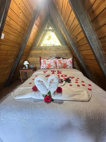 a bedroom with a bed in a attic at A-Frame da Lagoa in Imaruí