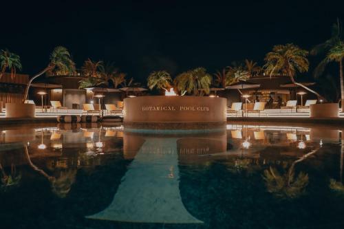 a swimming pool at a resort at night at BOTANICAL POOL CLUB in Kyonan