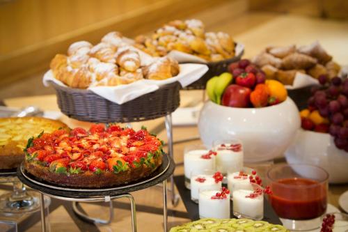 a table topped with lots of different types of food at Starhotels President in Genova