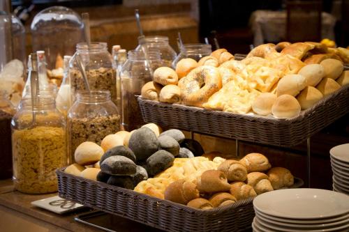 two baskets filled with different types of pastries on a counter at Starhotels President in Genova