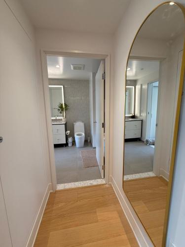 a hallway with a mirror and a bathroom at Thrive Nest in San Francisco