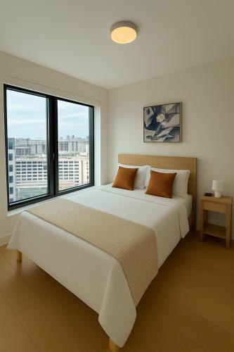 a white bedroom with a large bed with windows at Thrive Nest in San Francisco