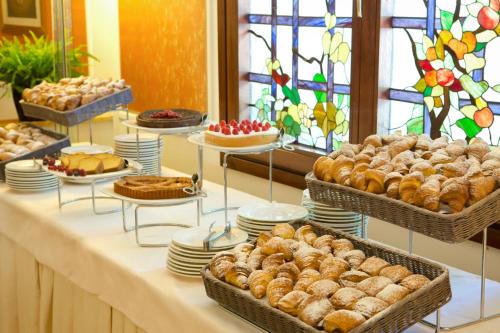 a buffet of pastries and breads on a table at Starhotels Du Parc in Parma