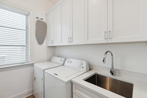 a white kitchen with a sink and a dishwasher at 132 Ocean Estates Dr in Lakewood Park