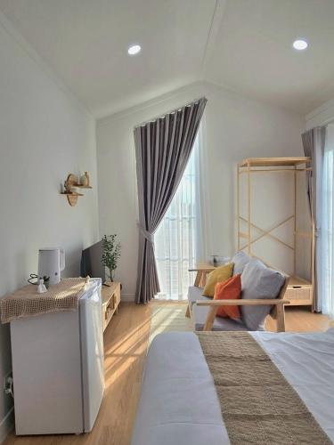 a bedroom with a bed and a chair and a window at Waveway bangsaen 1 in Ban Thai Don (2)