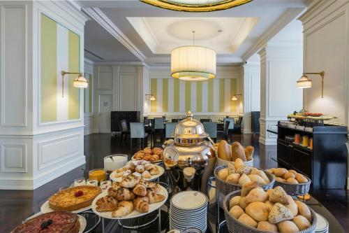 a table with many different types of breads and pastries at Savoia Excelsior Palace Trieste - Starhotels Collezione in Trieste