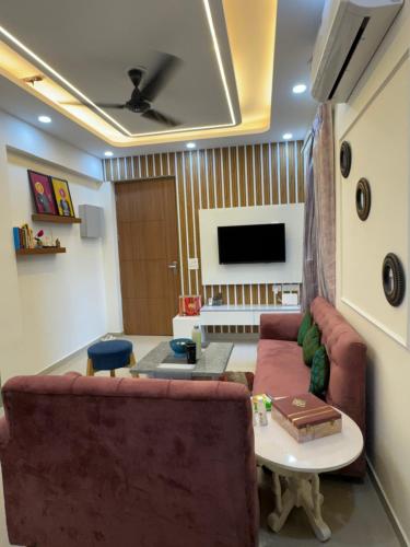 a living room with a couch and a table at Hideaway Nest in Ghaziabad