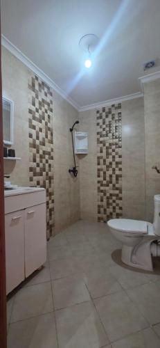 a bathroom with a toilet and a sink and a tub at appartement sable dor in Mohammedia