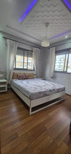 a bedroom with a large bed in a room at appartement sable dor in Mohammedia