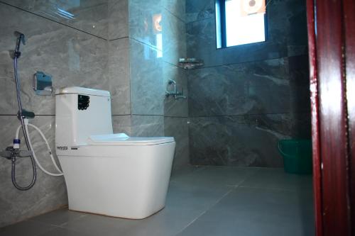 a bathroom with a toilet and a shower at Radiant Sky Hotel in Kuchāman City