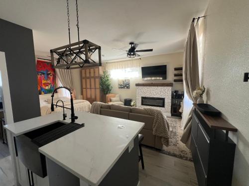 a kitchen and living room with a couch and a table at Su Casa Studio in Denver