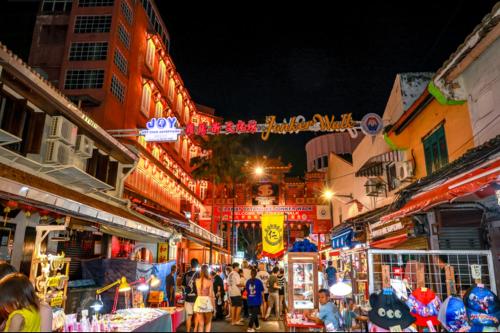 a crowd of people walking through a market at night at Vintage Inn Jonker Walk Melaka in Melaka