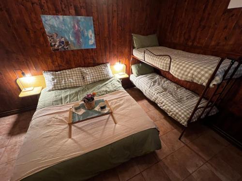 a bedroom with two bunk beds and a table at Apartment surrounded by the peace of nature in Torgnon