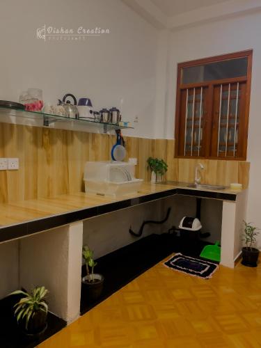 a kitchen with a counter with a sink and some plants at Villa 592A - Hikkaduwa in Hikkaduwa