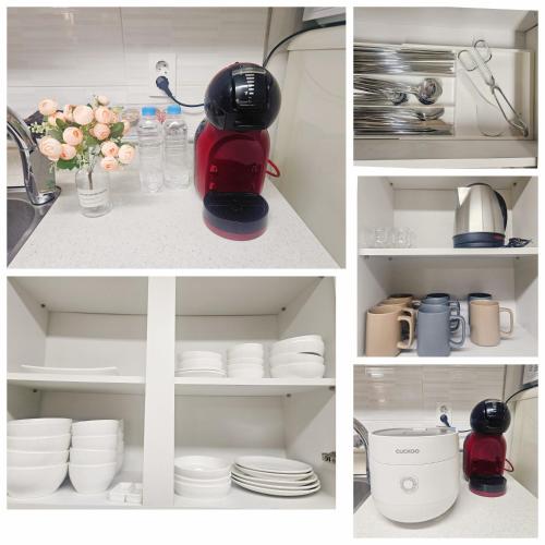 a kitchen with white dishes and a red mixer at 인천 청라3룸 인천공항 아시아드경기장 가족숙소 in So-yŏm