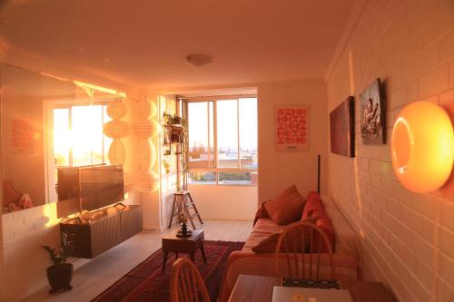 a living room with a couch and a window at Heart of Freo - Ocean Views in Fremantle