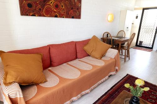 a brown couch in a living room with a table at Heart of Freo - Ocean Views in Fremantle