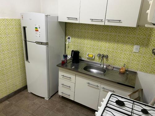 a kitchen with a white refrigerator and a sink at Ideal Centro Junin in Junín