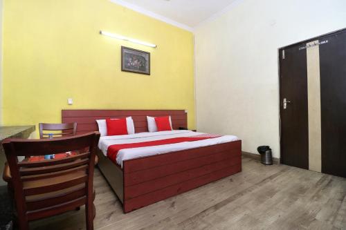 a bedroom with a bed and a table and chairs at Hotel O Star INN in Jalandhar