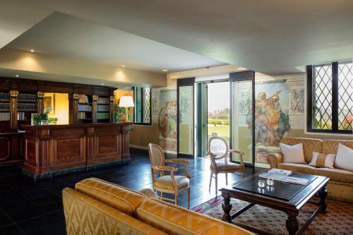 a living room with a couch and a table at Villa Michelangelo Vicenza – Starhotels Collezione in Arcugnano
