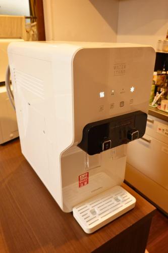 a white sewing machine sitting on top of a table at Fukuoka Guest House Jikka in Fukuoka