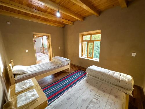 a room with two bunk beds and a window at Nur Homestay in Nurata Mountains in Yukary-Ukhum
