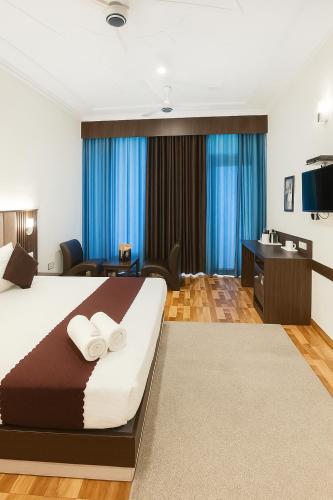 a hotel room with a bed and a bathroom at The Kasauli woods in Kasauli