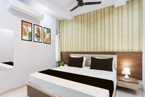 a bedroom with a large bed and a green wall at Hotel O Shree Vishwanath in Varanasi
