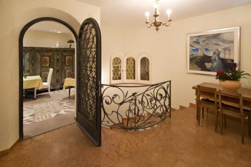 a room with a gate and a dining room at Boutique Hotel Albergo Brione in Locarno