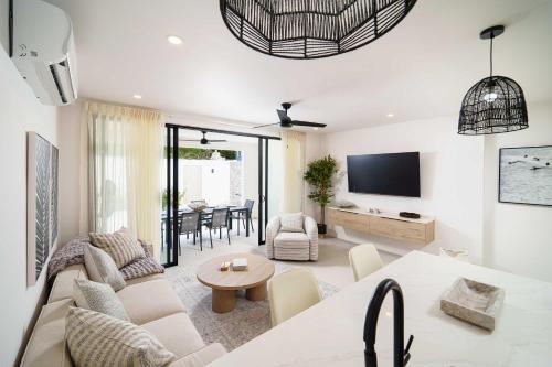 a living room with a couch and a table at Walk to Beach New Stylish 3BR Pool in Saint James
