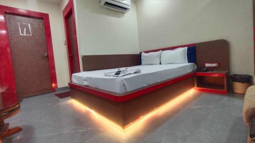 a bedroom with a bed with lights on the floor at Collection O A&M Regency, WEBLE More in Thākurdwari