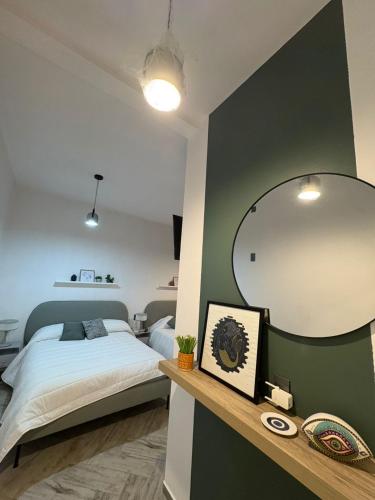 a bedroom with a bed and a large mirror at Loft ËNXË Boutique Habitación Olivo in Cuetzalán del Progreso