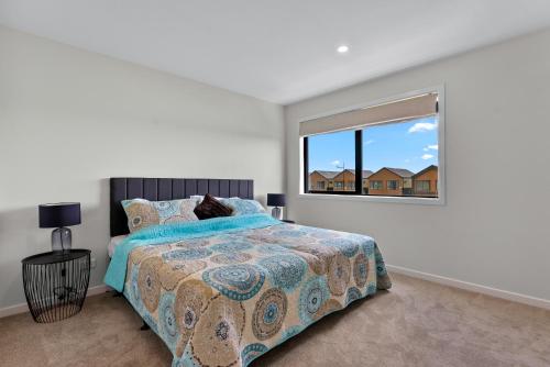 a bedroom with a bed and a window at Its a bit country and a bit town in Karaka