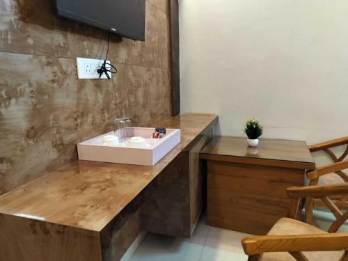 a bathroom with a sink on a wooden counter at Collection O Uttaranchal University Premnagar in Jhājra