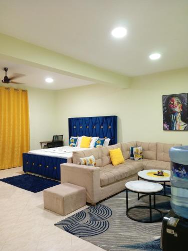 a living room with a couch and a bed at Spacious Calitwapa Studio Apartment with AC and Private cook upon request available in Mtwapa