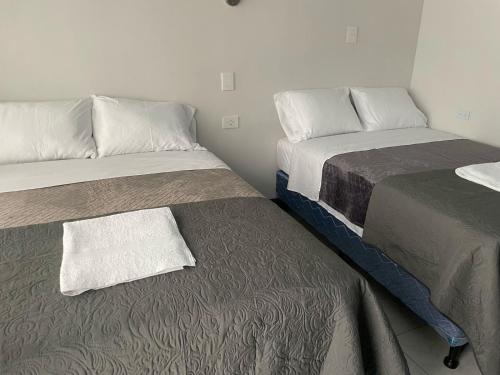 Postel nebo postele na pokoji v ubytování Hotel Orquídea