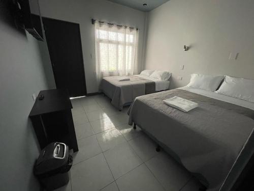 Postel nebo postele na pokoji v ubytování Hotel Orquídea