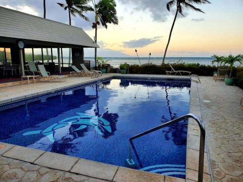 a swimming pool with a view of the ocean at Oceanfront true 2 bedroom wlanai on Molokai in Ualapue