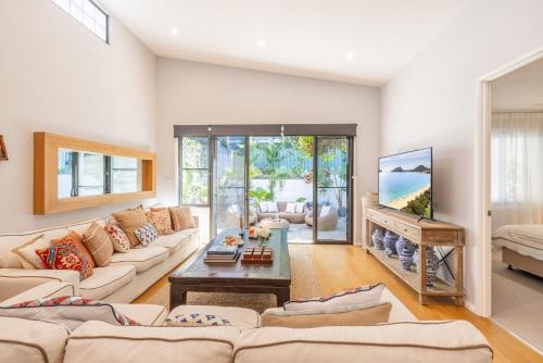 a living room with a couch and a fireplace at 6A Hough Street - Sophisticated pet friendly home with air con, wi-fi and linen provided in Nelson Bay