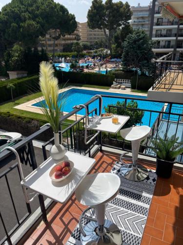 a balcony with two tables and a bowl of fruit at Apartment in Salou in Salou