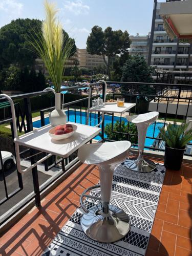 a balcony with two tables and a bowl of fruit at Apartment in Salou in Salou